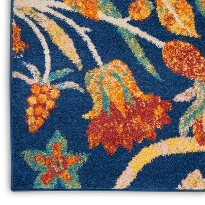 Vibrant blue floral rug with orange, yellow and red blossoms, green leaves; shaggy tufted texture for modern home decor.