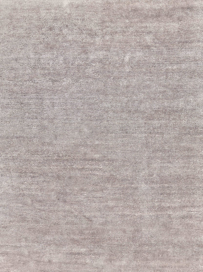 Taupe-gray textured rug with a mottled plush pile; soft, versatile for living room or bedroom.