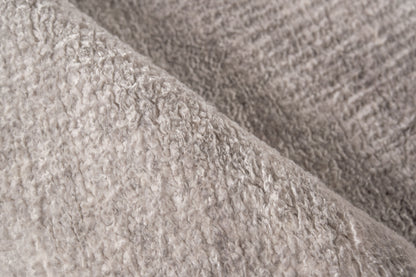 Beige plush rug close-up showing soft fluffy pile.