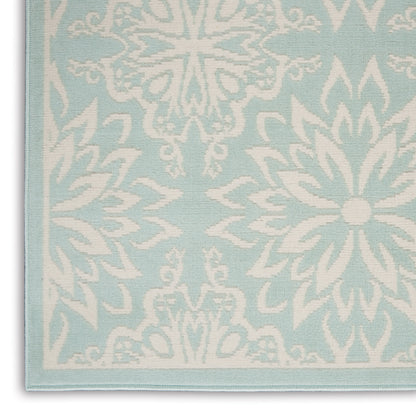 Light blue rug with white damask pattern and pale blue border; decorative 5' x 7' rug.