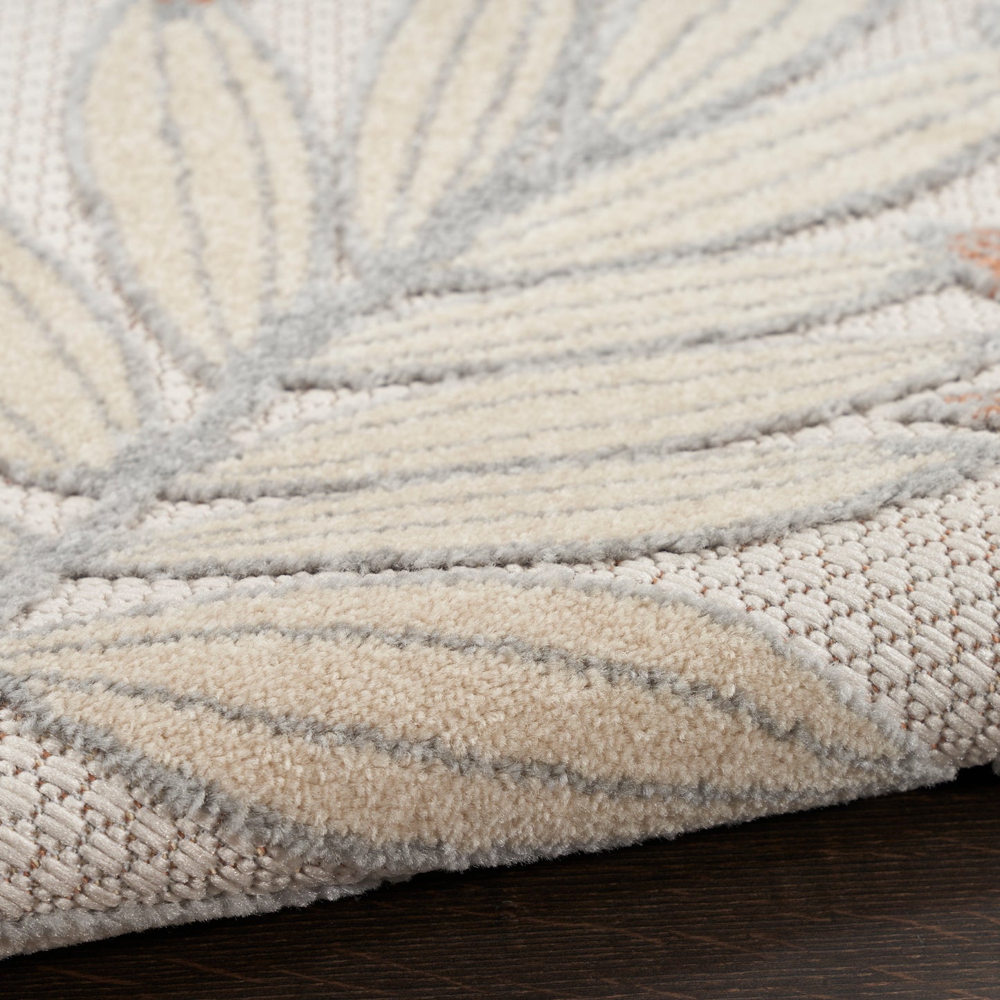 Cream and beige rug with soft plush pile and leaf-like pattern, woven texture for neutral decor.