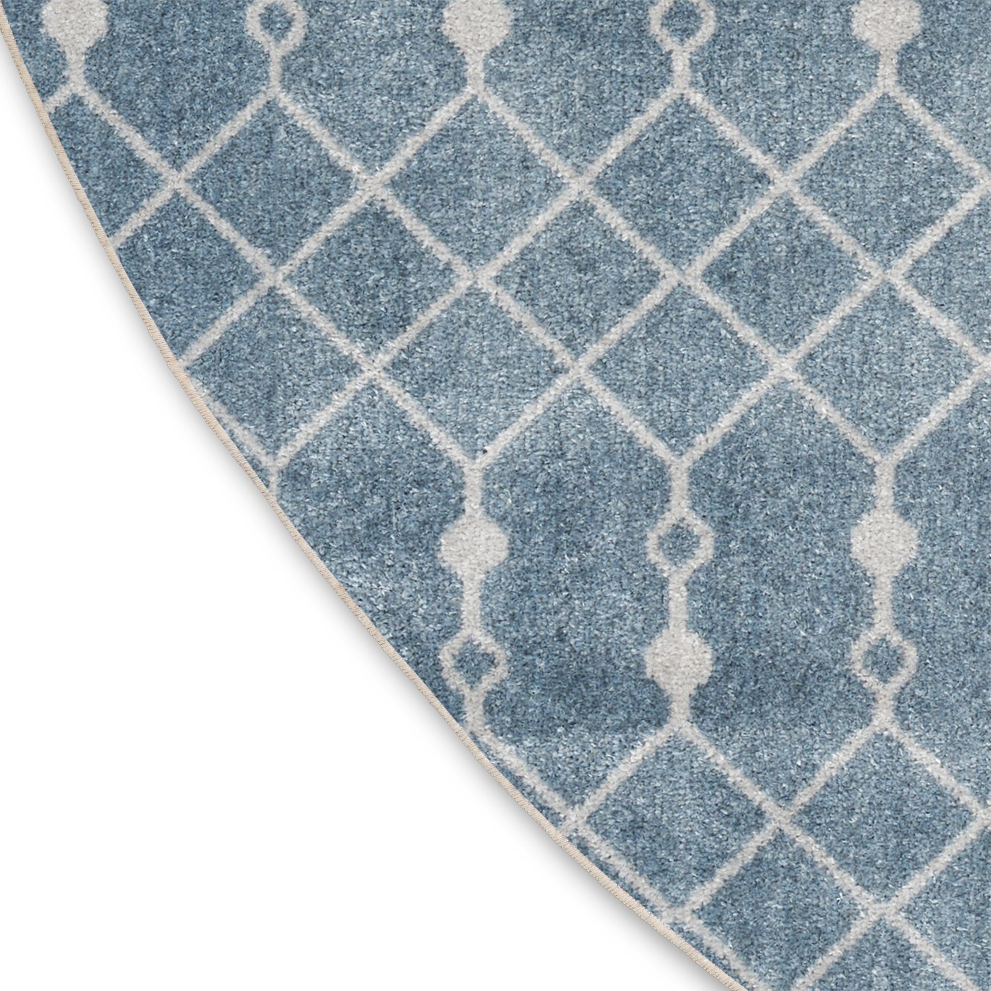 Blue rug with white lattice trellis pattern, diamond motif, soft woven texture, ideal for living room decor.