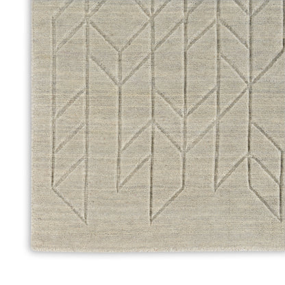 Beige flat-weave rug with taupe geometric chevron pattern; modern rectangular area rug.