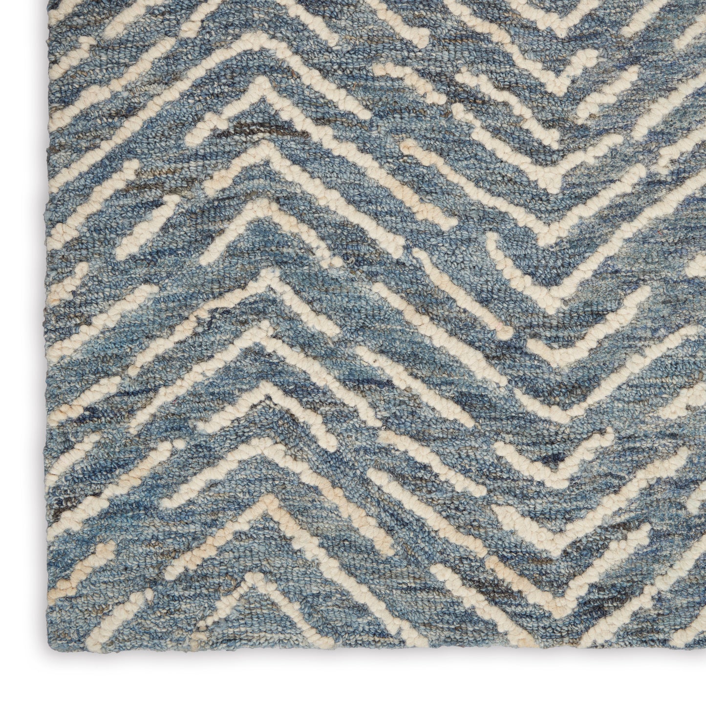 Blue and ivory chevron rug with plush loop pile and textured zigzag pattern.