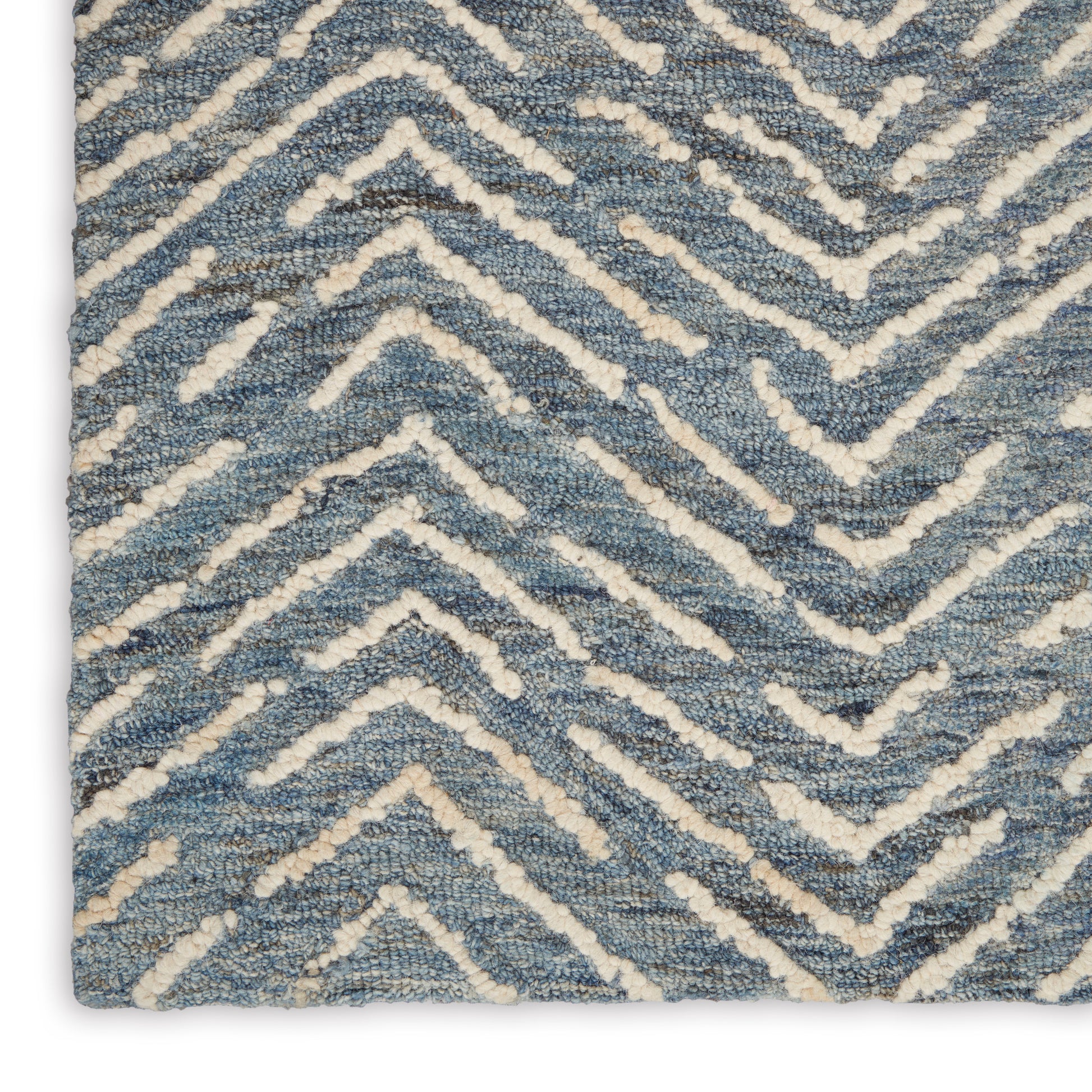 Blue and ivory chevron rug with plush loop pile and textured zigzag pattern.