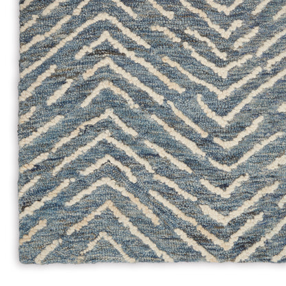 Blue and ivory chevron rug with plush loop pile and textured zigzag pattern.