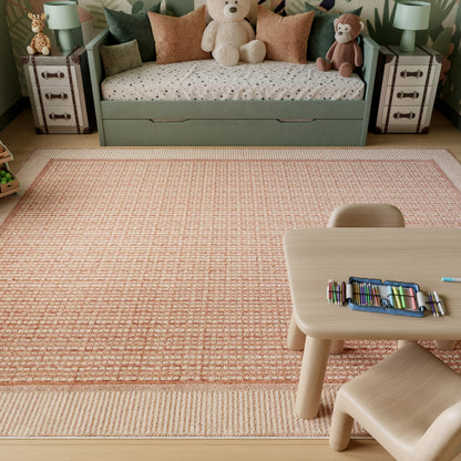 Pastel green kids' daybed with under-bed storage, polka-dot duvet, stuffed bear, toy monkey, peach rug, table and chairs.