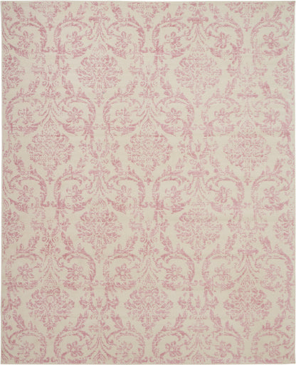 Cream area rug with pastel pink damask pattern; ornate floral motifs, woven textile.