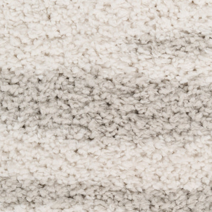 Cream shag rug with thick, plush pile and subtle tonal shading; perfect for cozy living room floors.