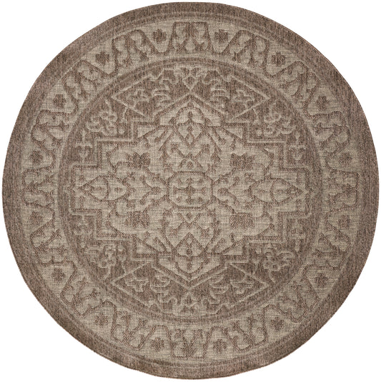 Round beige-brown rug featuring an ornate oriental geometric medallion pattern and textured surface.
