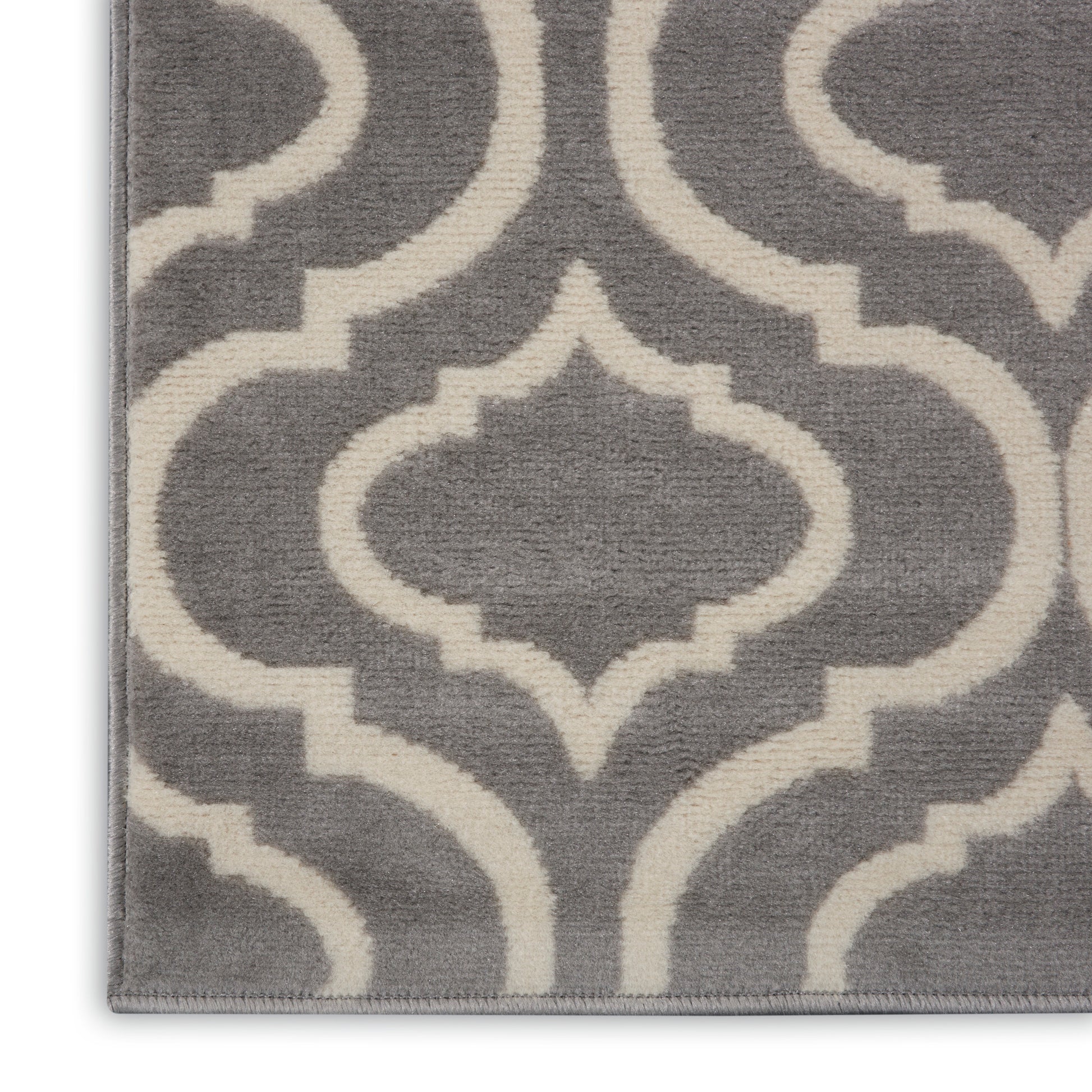 Gray runner rug with white trellis pattern; plush pile, modern Moroccan-inspired design, bound edges.
