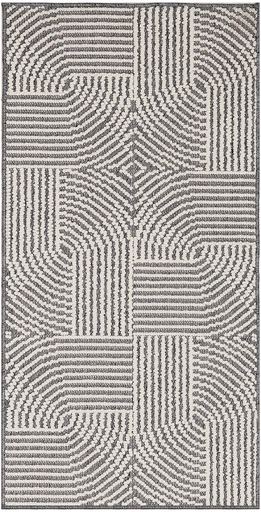 Cream and charcoal looped-pile rug with patchwork panels of striped, curved and grid-like patterns.