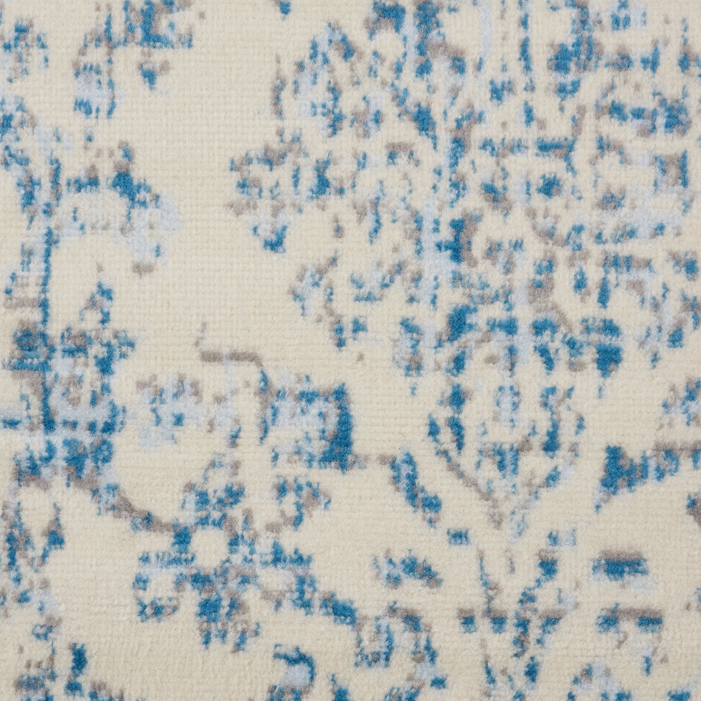 Cream woven fabric with blue distressed floral damask pattern.