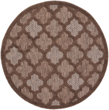 Round brown rug with repeating beige quatrefoil lattice pattern and textured weave, dark border.