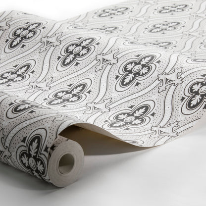 Rolled white wallpaper with black floral pattern, featuring four-petal flowers and curling paisley motifs.