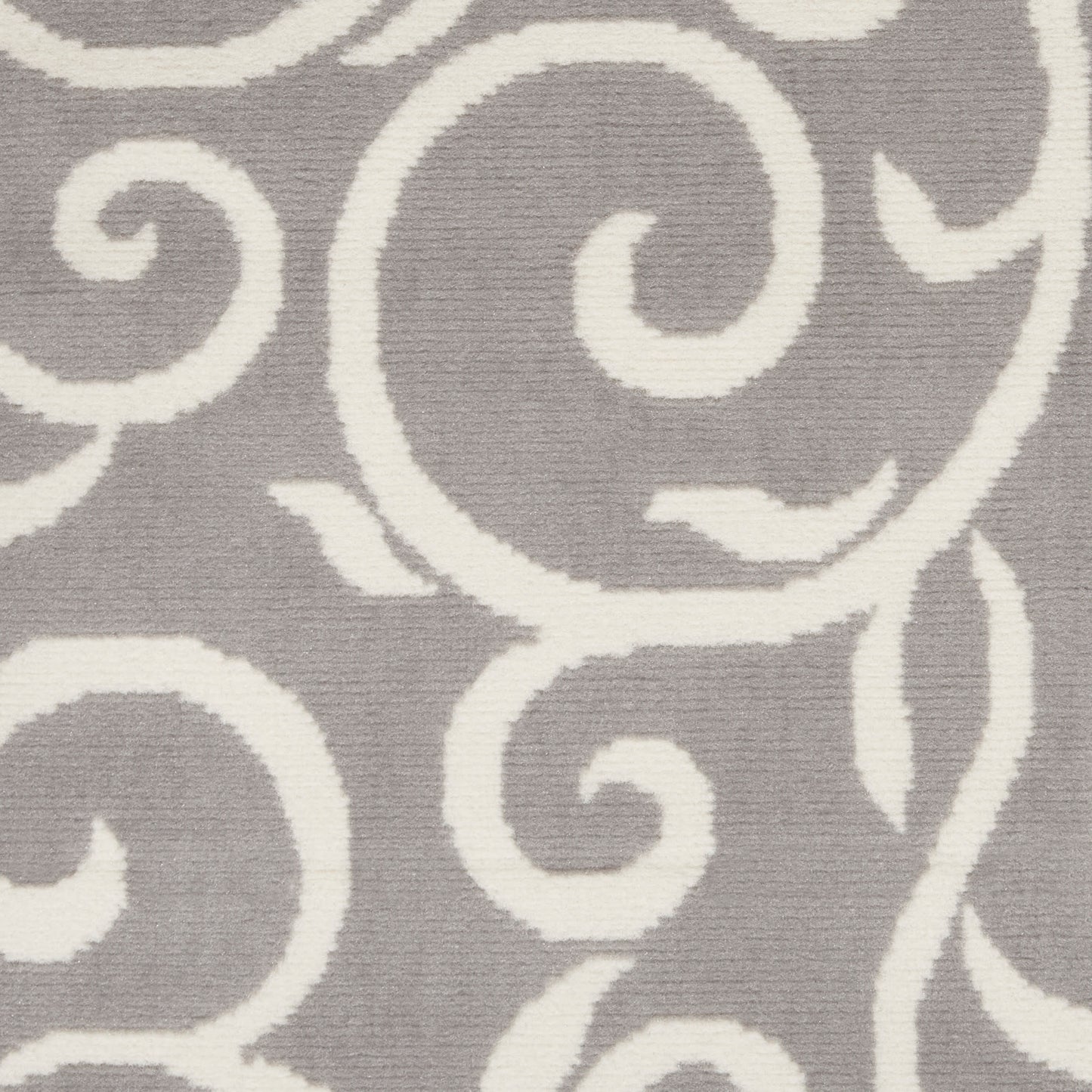 Gray rug with bold white swirling scroll pattern and soft textured pile for modern living spaces.