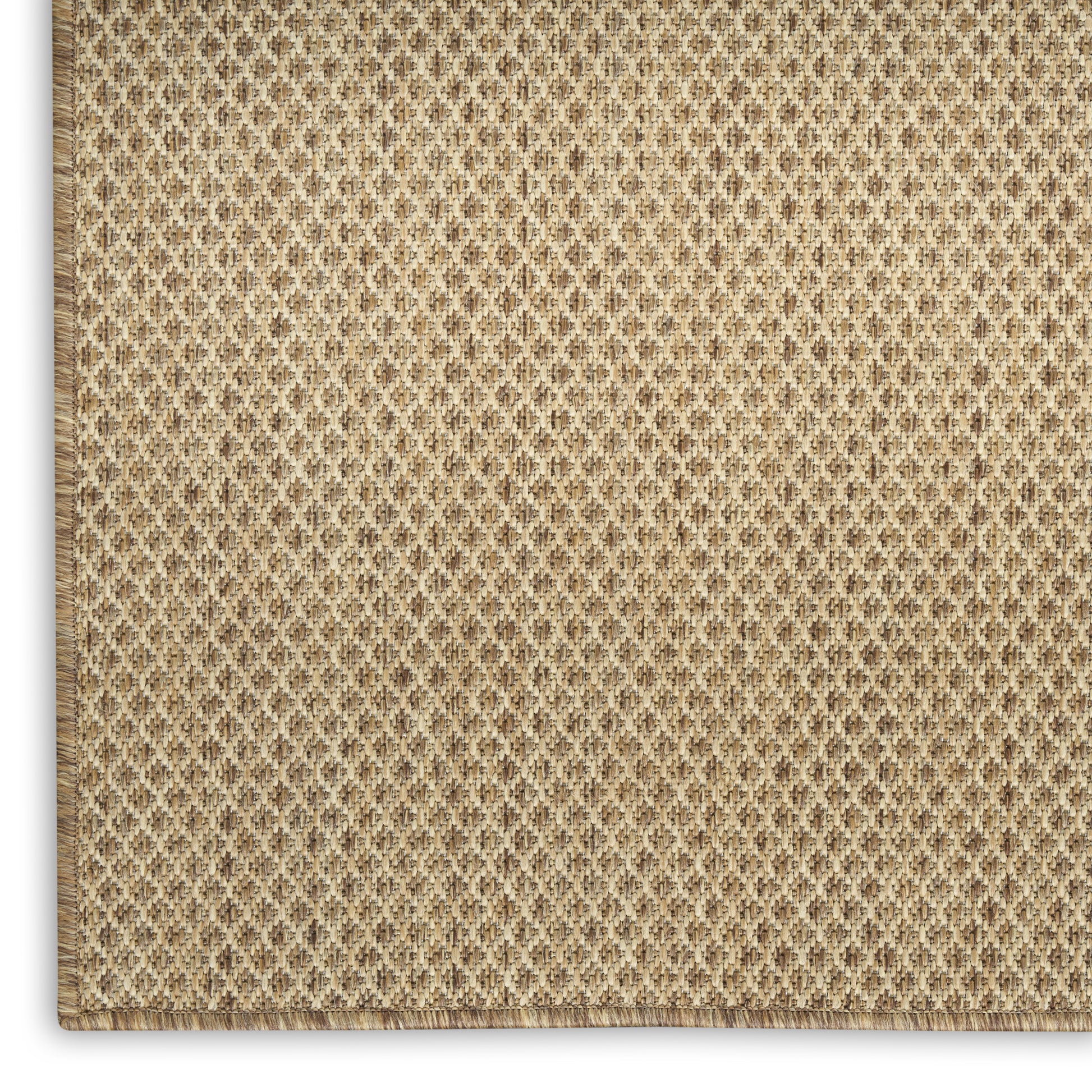 Beige woven jute rug close-up with diamond texture and stitched border.