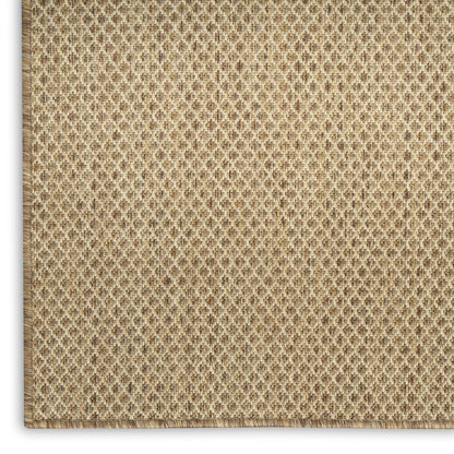 Beige woven jute rug close-up with diamond texture and stitched border.