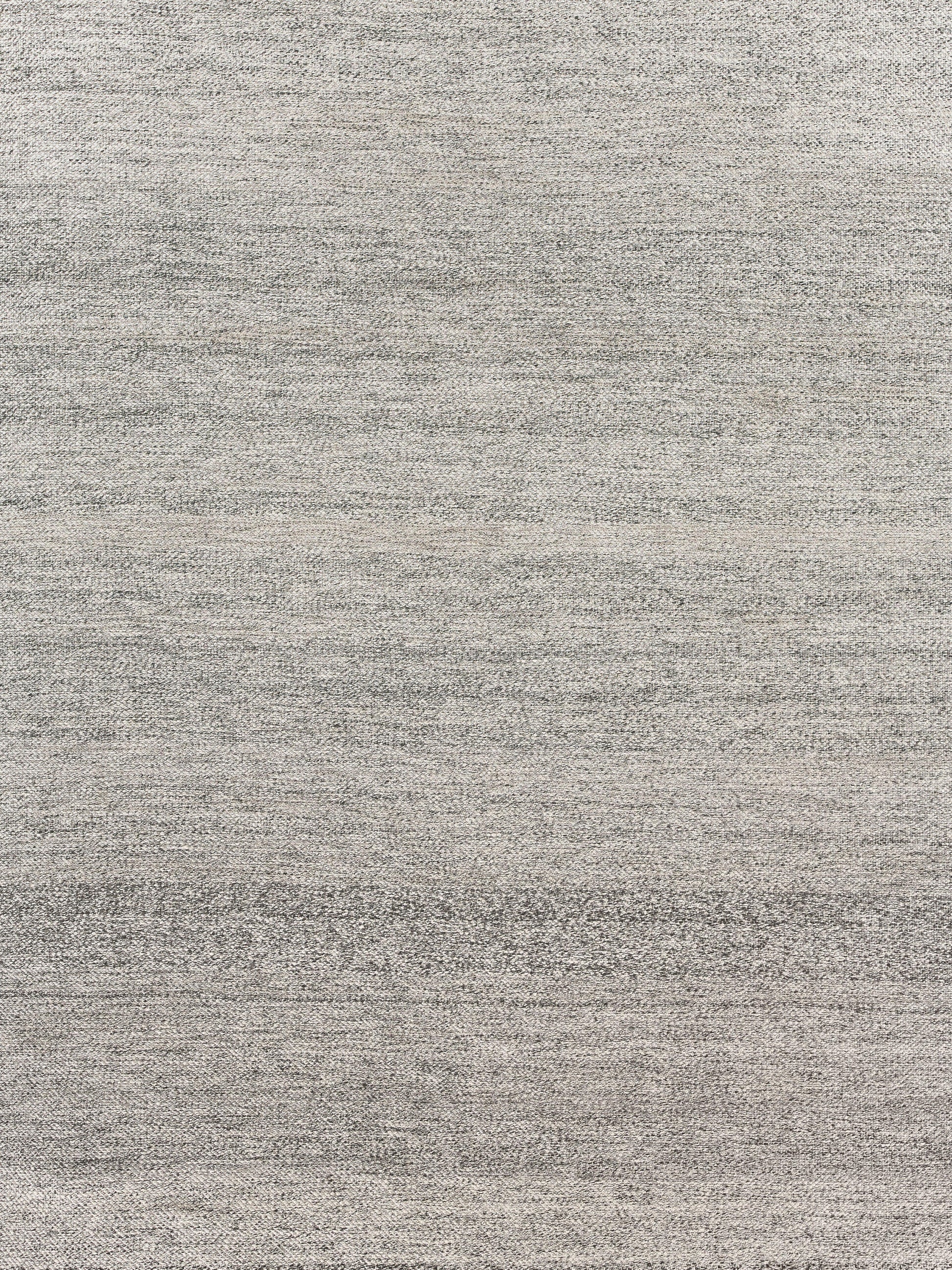 Light gray heathered woven rug texture with subtle tonal variation.