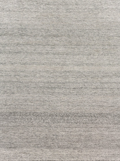 Light gray heathered woven rug texture with subtle tonal variation.