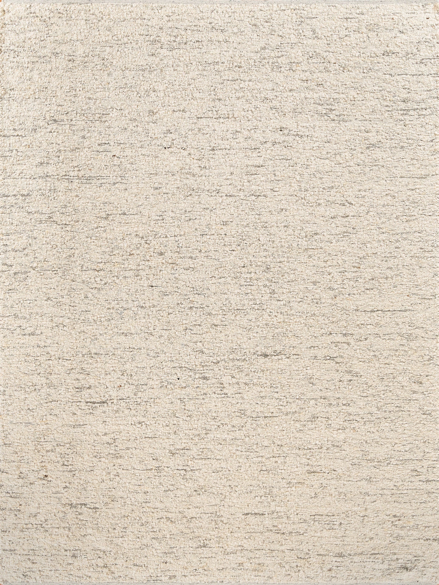 Beige flat-weave rug with subtle mottled texture in cream and tan tones.