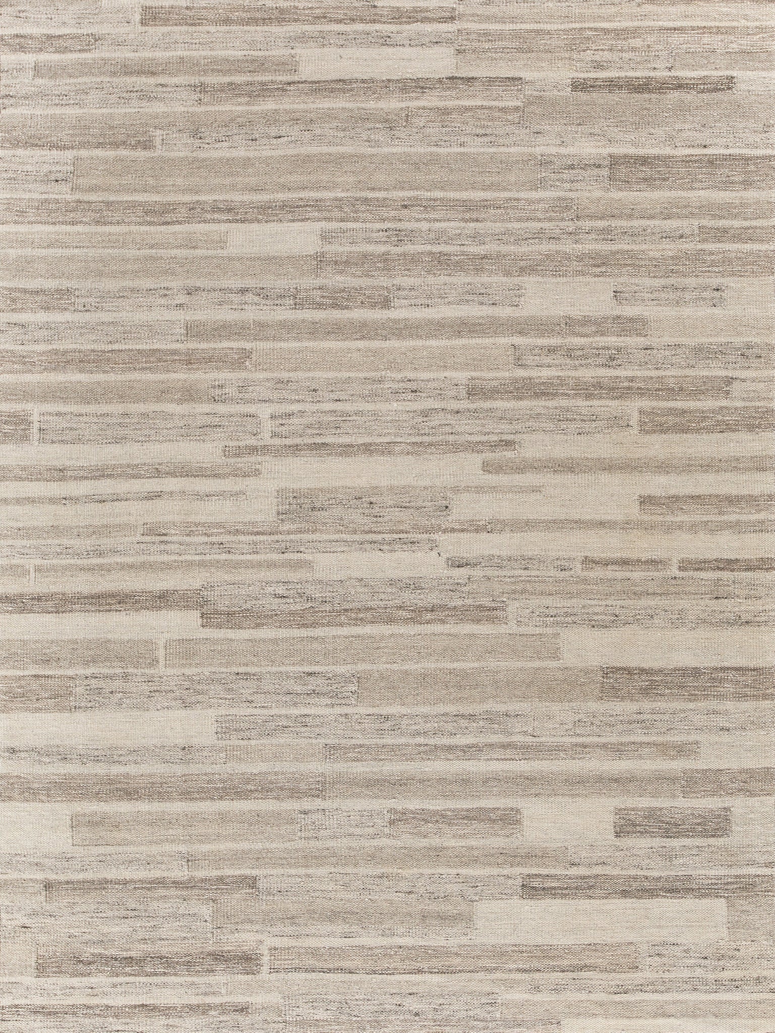 Beige taupe hand-loomed rug with a subtle linear weave; indoor Scandinavian-style rug.