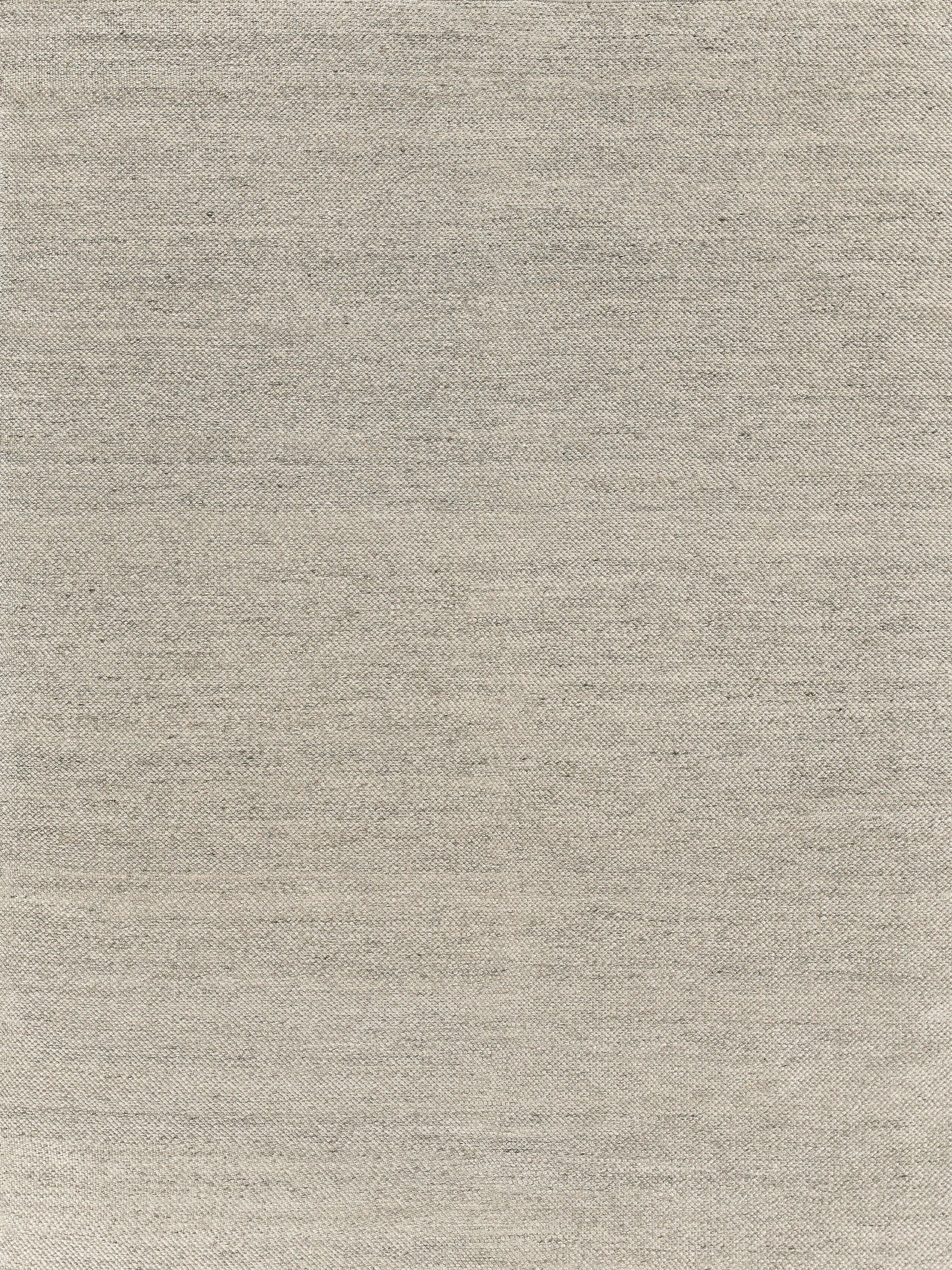 Beige hand-loomed rug with subtle slub texture; indoor use. 5'6" x 7'6