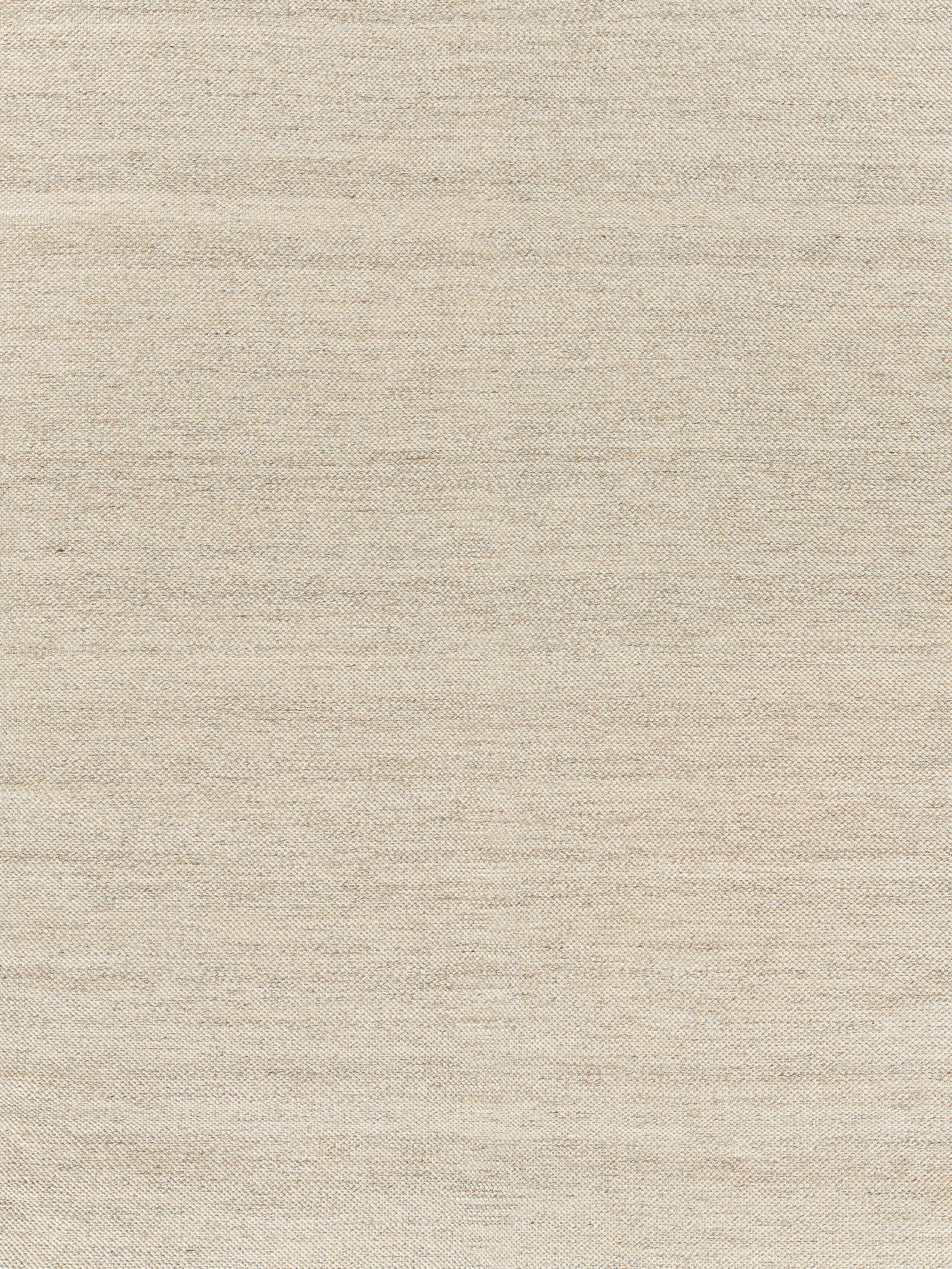 Beige woven rug texture with natural fibers; warm neutral appearance.