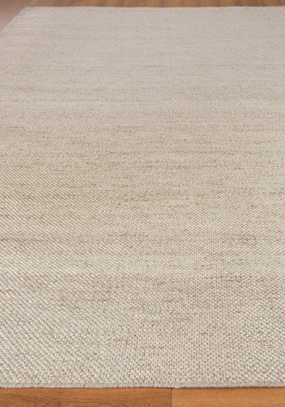 Natural beige hand loomed rug with a textured surface; rectangular, rustic farmhouse style; 9' x 12'; ideal for living room or hallway.