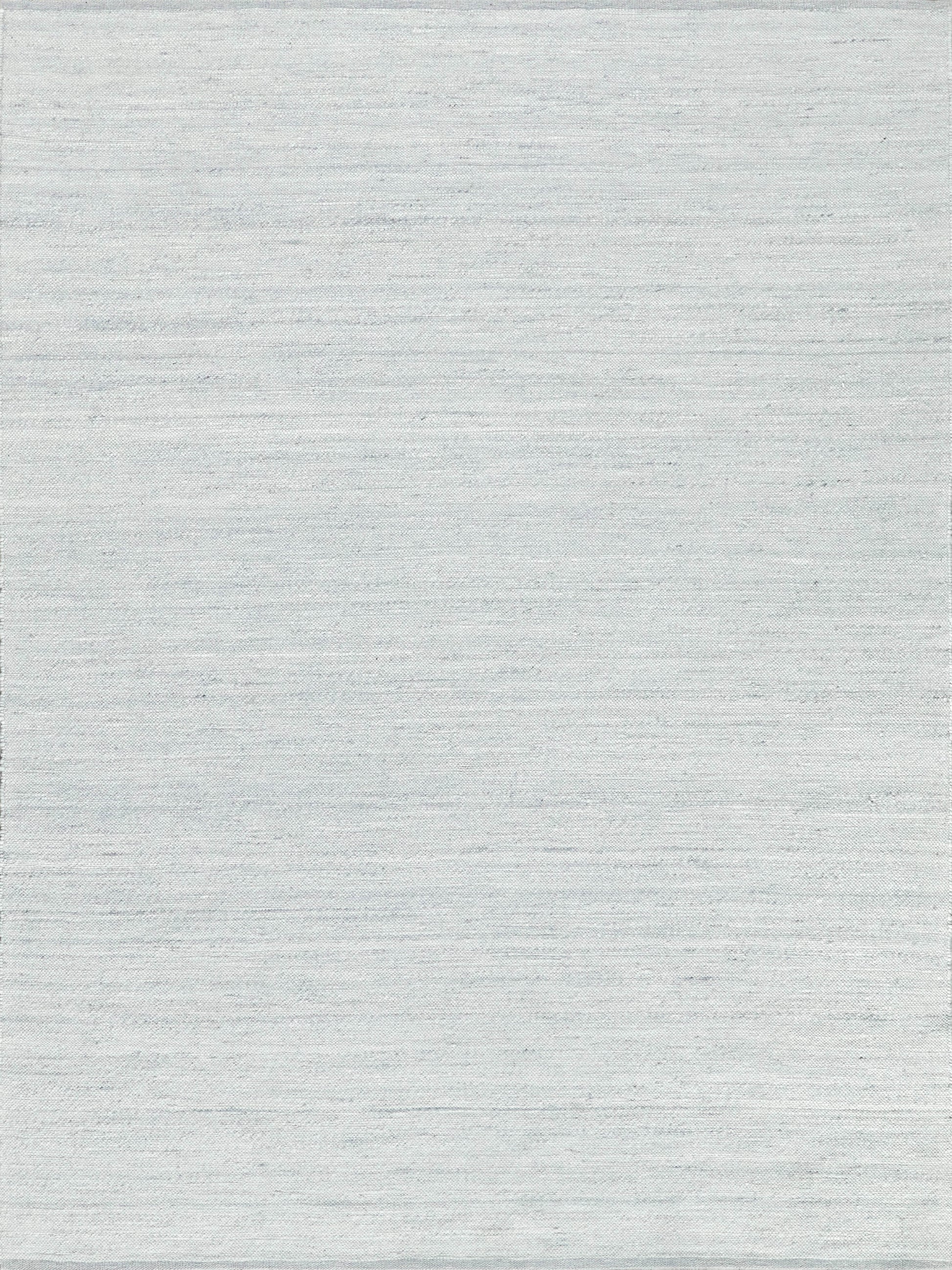 Rectangular light gray indoor flat-weave rug with subtle heathered texture and soft woven finish.