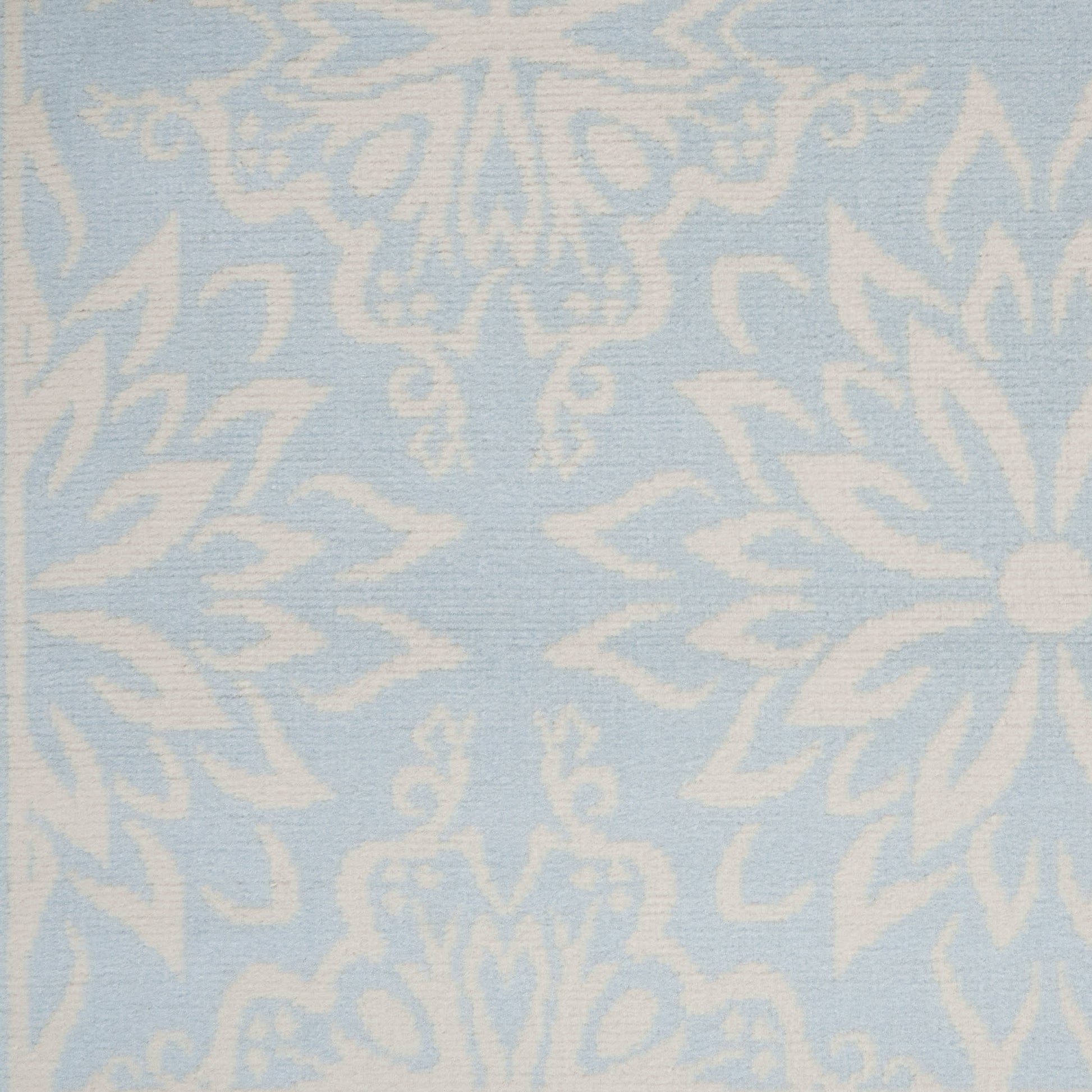 Light blue fabric with an intricate white damask floral pattern, classic decorative textile for upholstery.
