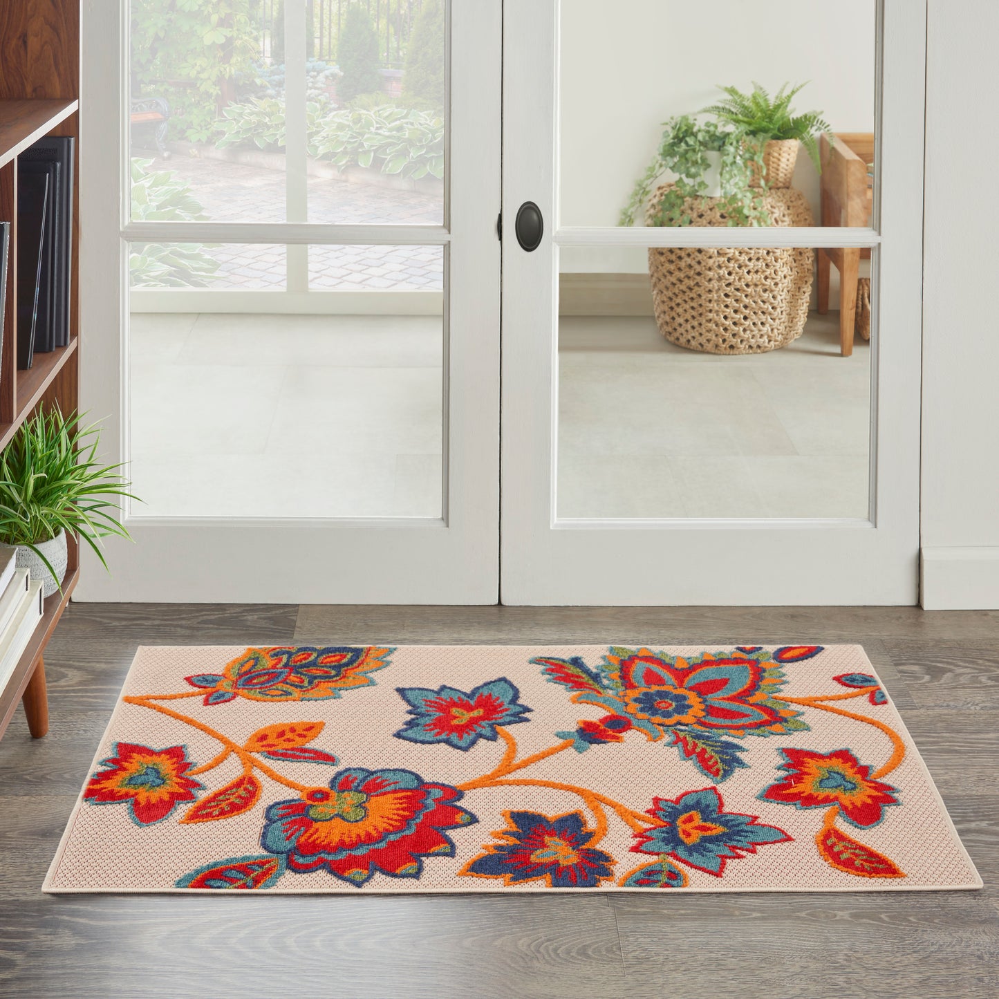 Rectangular beige contemporary rug with a bright multicolor floral motif in orange, red and blue on a light background, 3' x 4'.