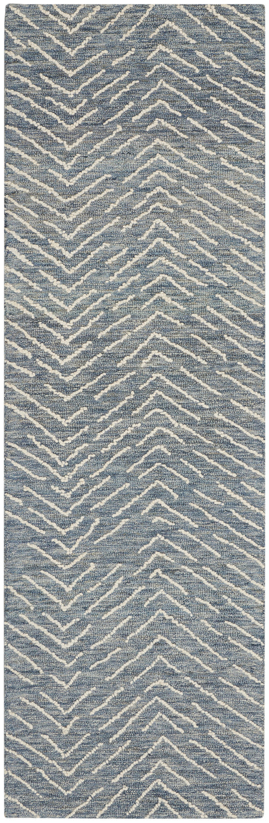 Blue textured rug runner with white chevron zigzag pattern.