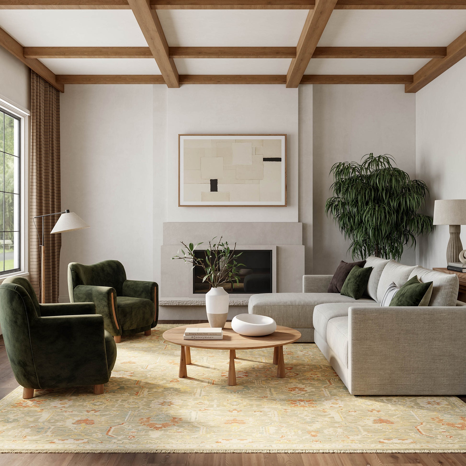 Neutral living room with a vintage 8' x 10' rug, beige sofa, green chairs, round wood coffee table, abstract art, fireplace, plant, exposed beams.