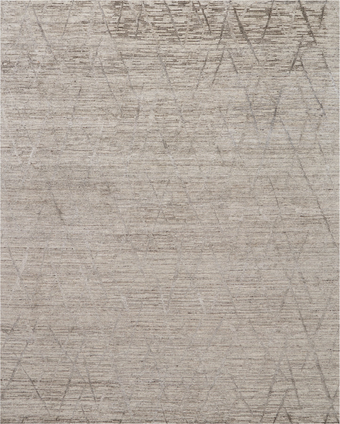 Neutral beige area rug with soft texture and a faint circular and diamond geometric pattern in taupe.