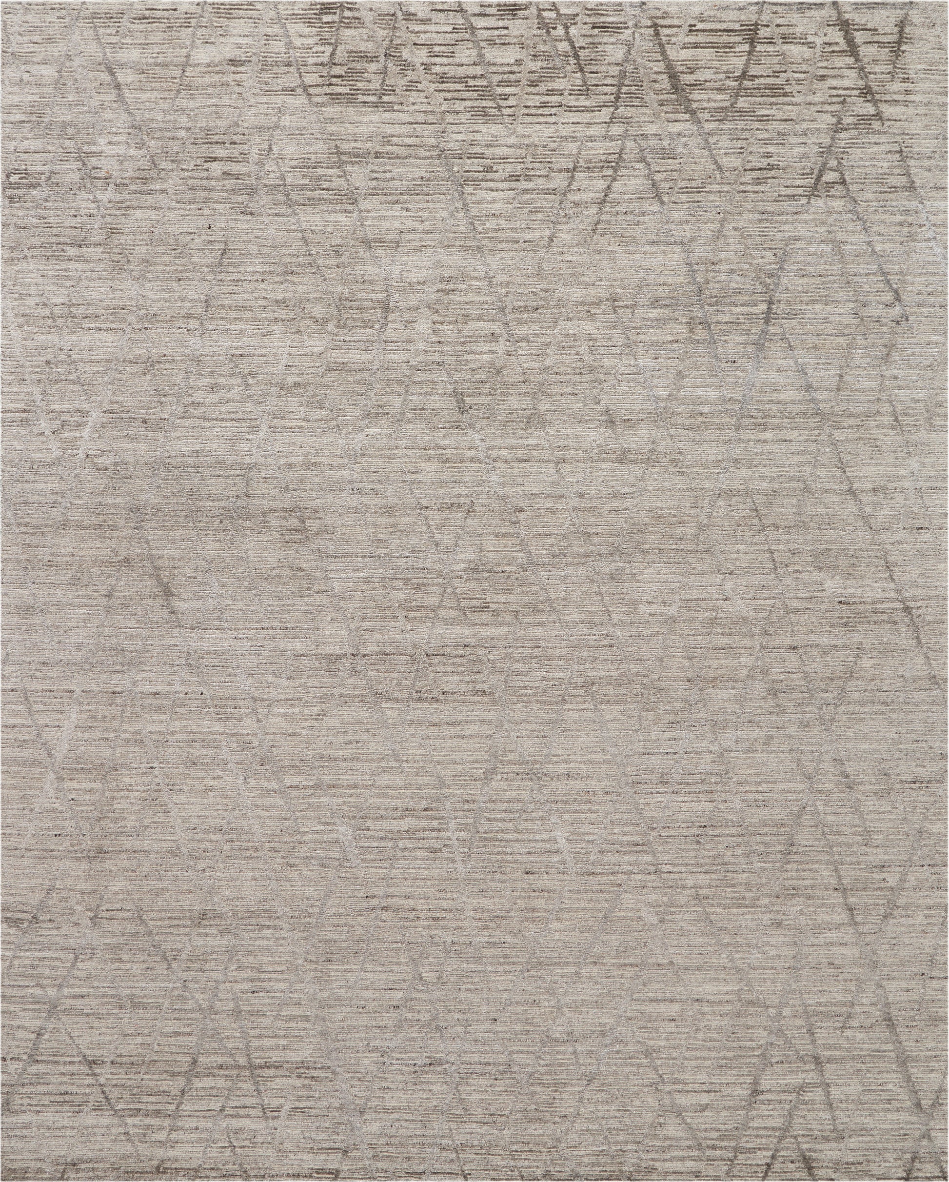 Neutral beige area rug with soft texture and a faint circular and diamond geometric pattern in taupe.