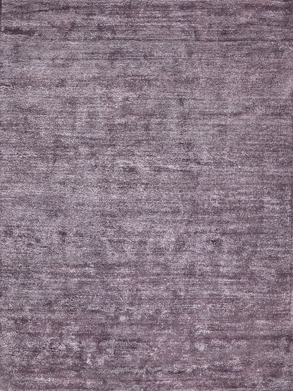 Muted purple-gray plush rug with distressed texture and rectangular shape.