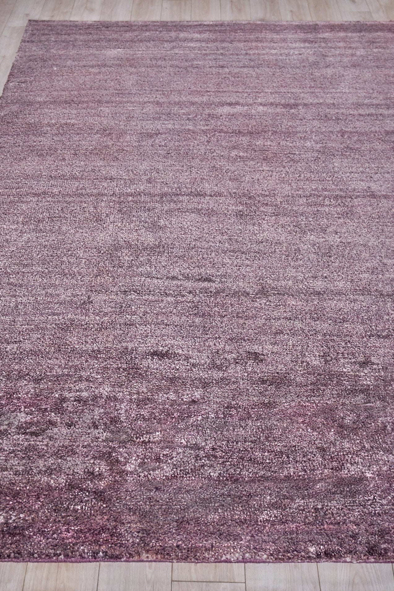 Rectangular mauve pink rug, plush indoor hand-knotted with subtle shading, 2' x 3'.