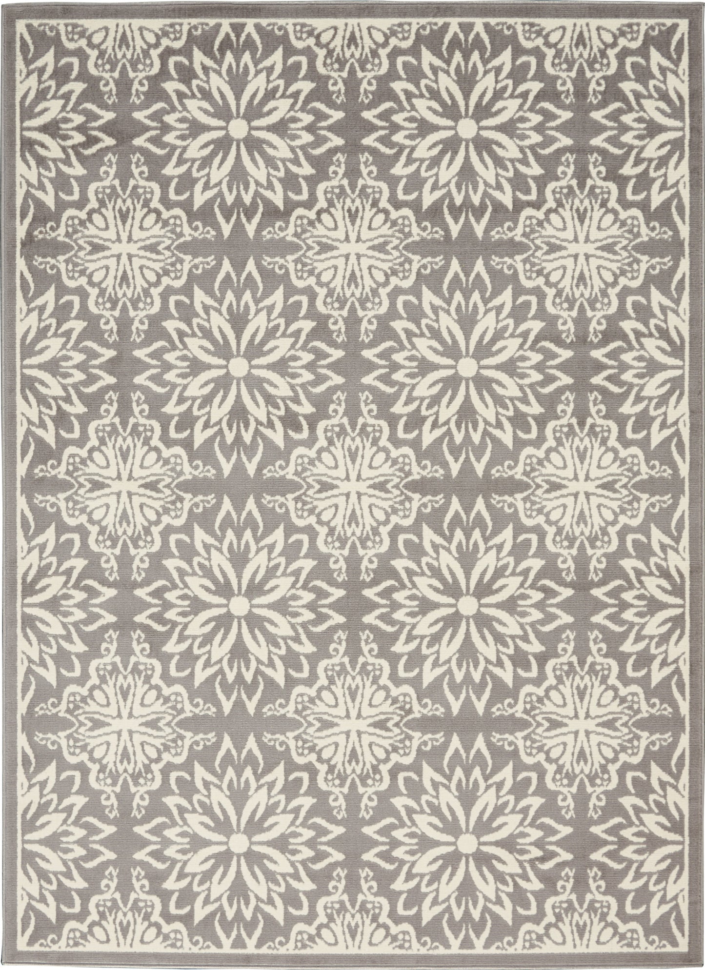 Rectangular grey area rug with repeating ivory floral medallion/starburst motifs and cream border.