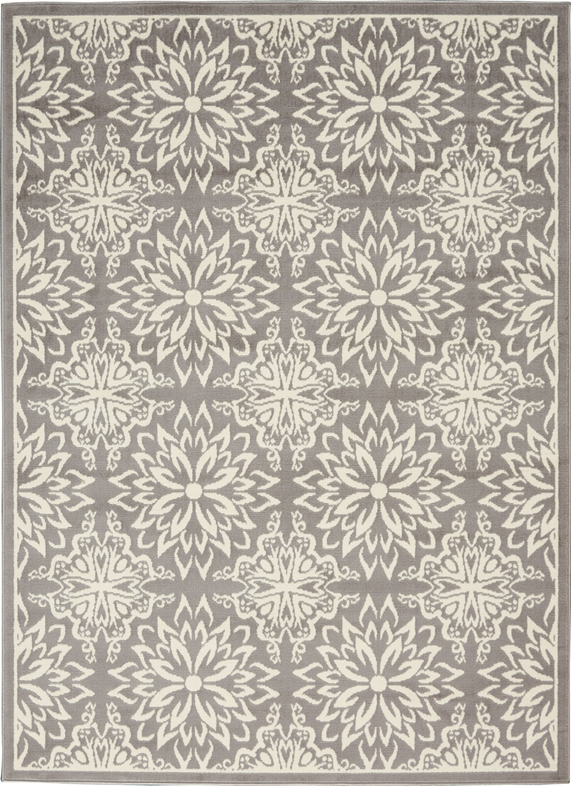 Rectangular grey area rug with repeating ivory floral medallion/starburst motifs and cream border.