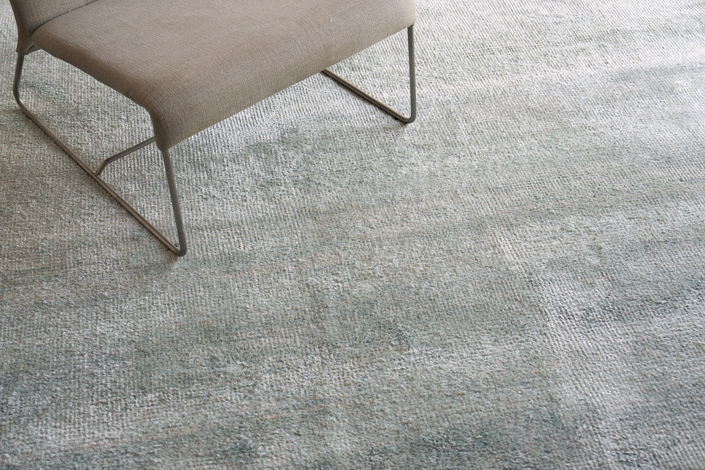 Plush indoor hand-knotted rug, 2' x 3', in blue-gray tones.
