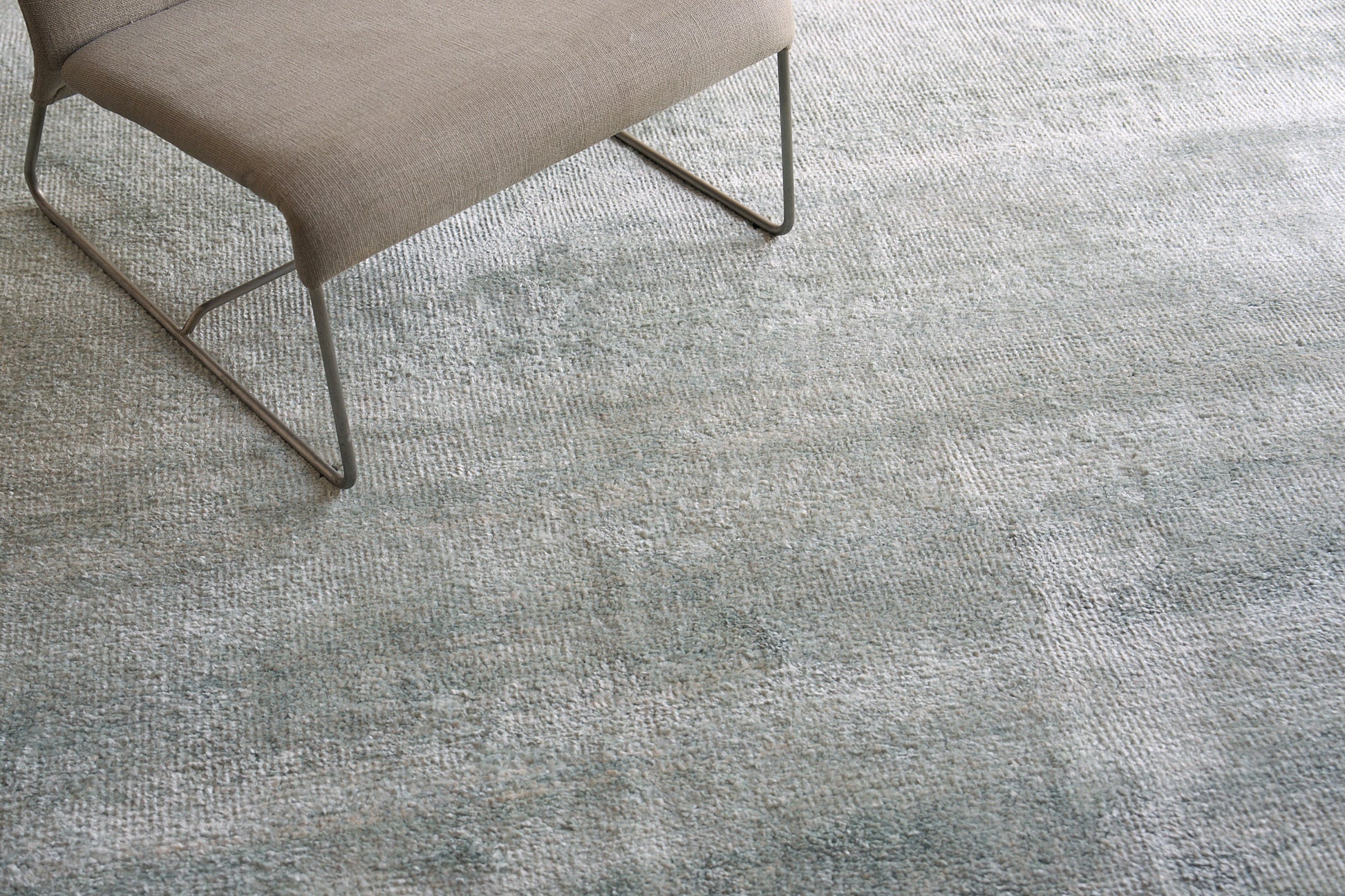 Plush indoor hand-knotted rug, 2' x 3', in blue-gray tones.