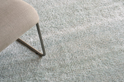 Blue-gray textured hand-knotted rug.