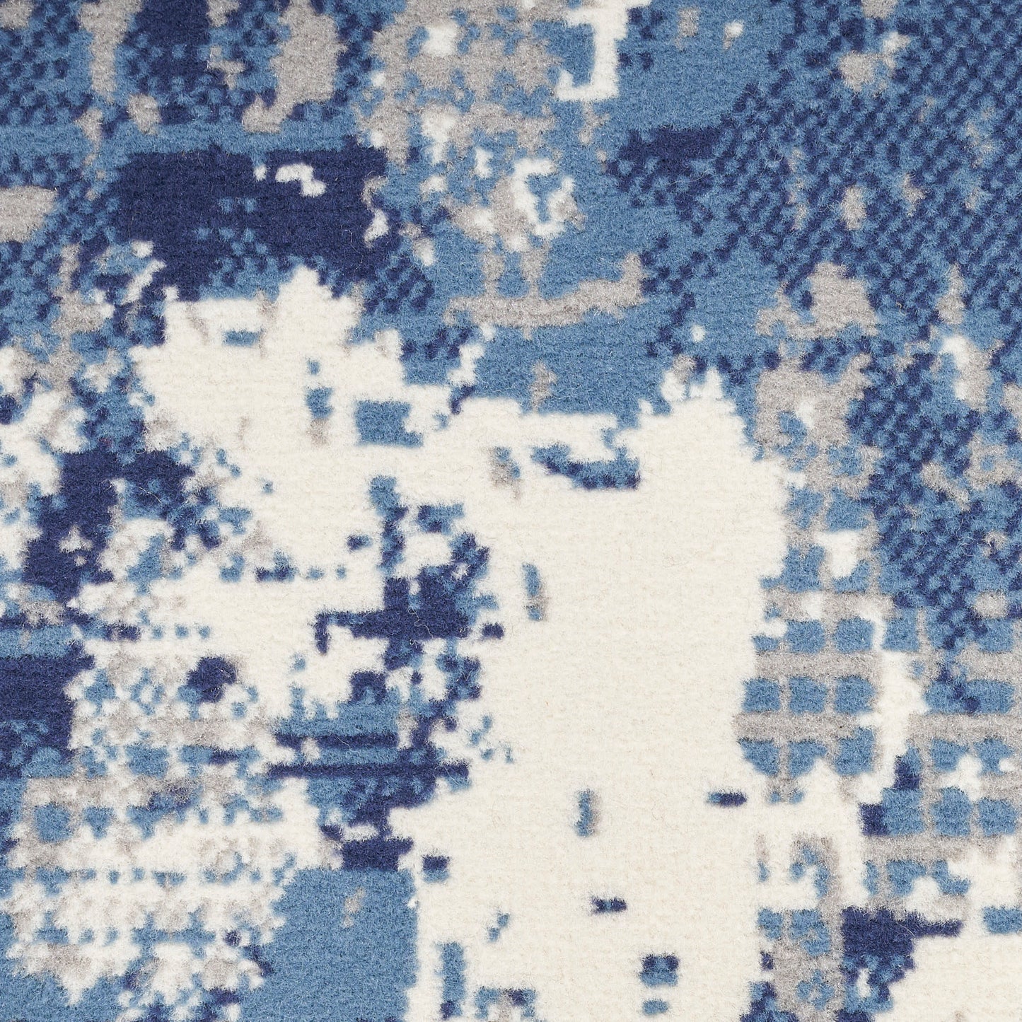 Blue and white pixelated, digital-camo pattern on a woven rug.
