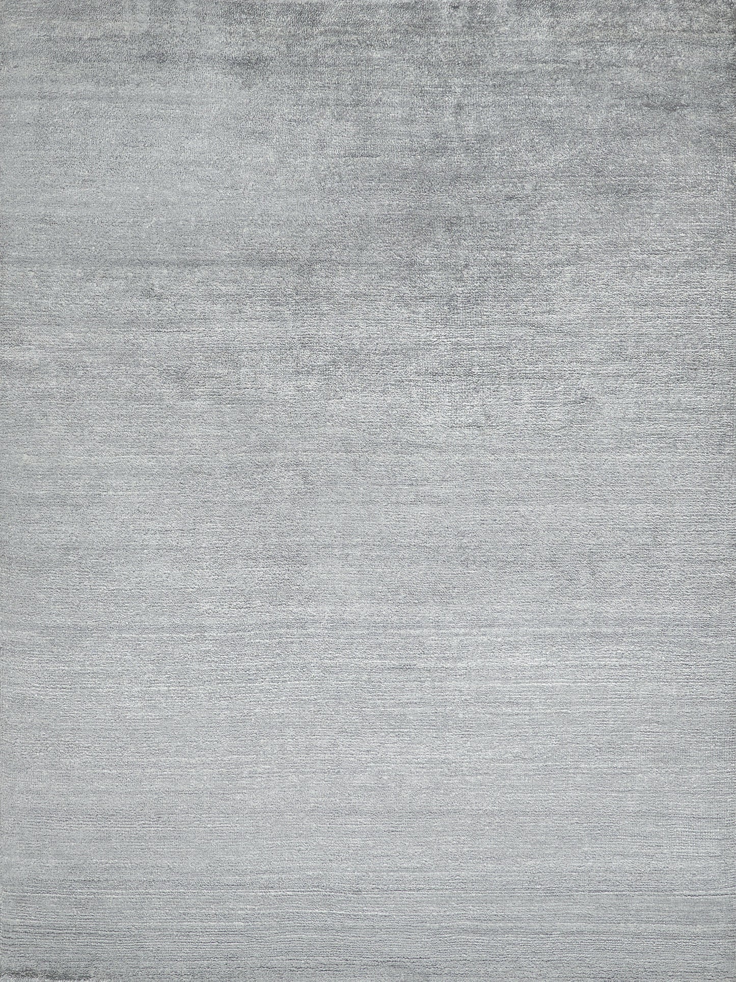 Flat gray brushed texture on a plush indoor hand-knotted rug; neutral surface with subtle horizontal grain.