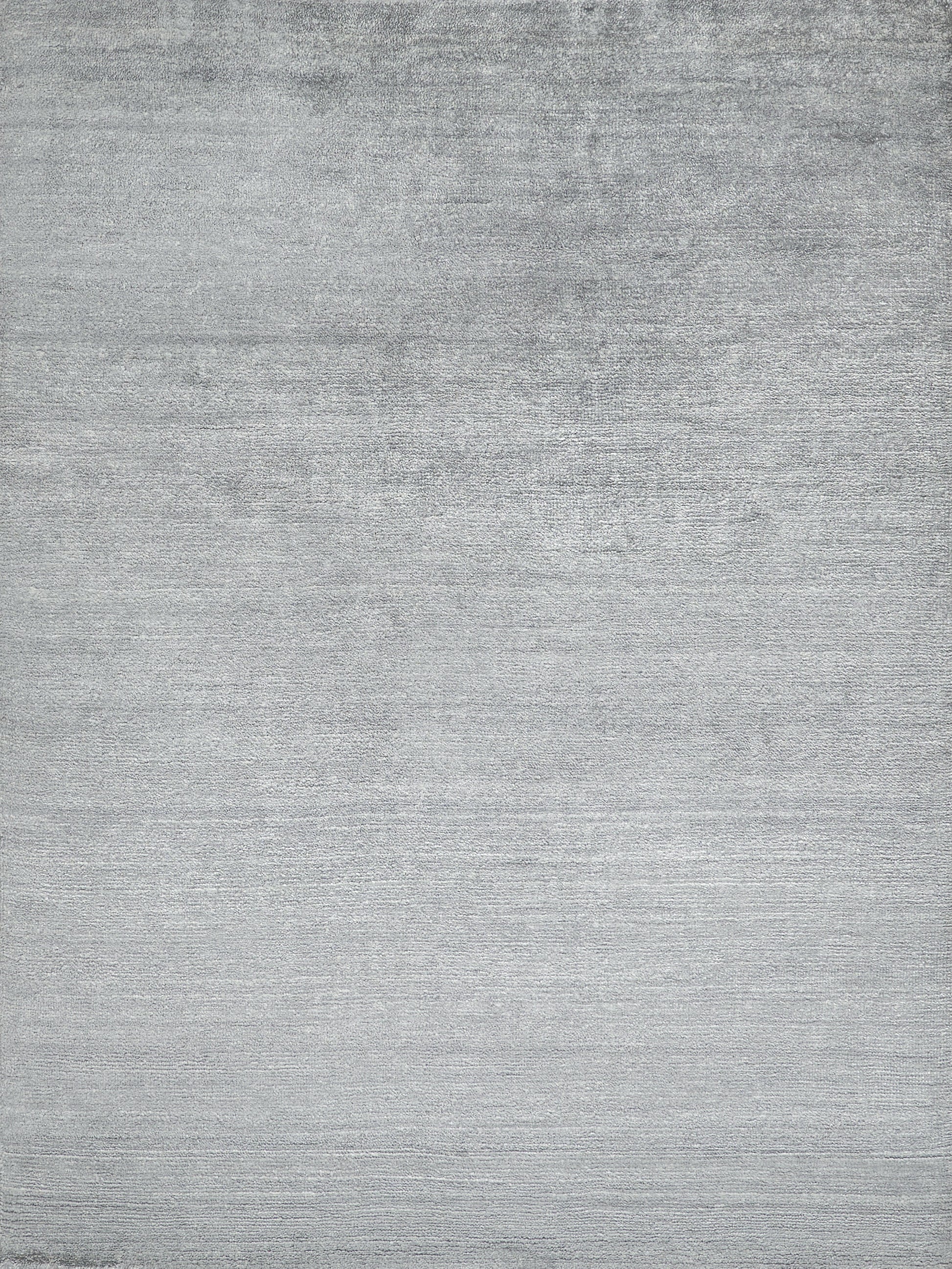 Flat gray brushed texture on a plush indoor hand-knotted rug; neutral surface with subtle horizontal grain.