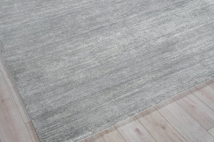 Rectangular gray textured rug with subtle heathered tones on light wood floor.