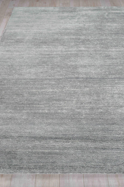 Gray textured hand-knotted indoor area rug with tonal variation on a light wood floor, 2' x 3'.