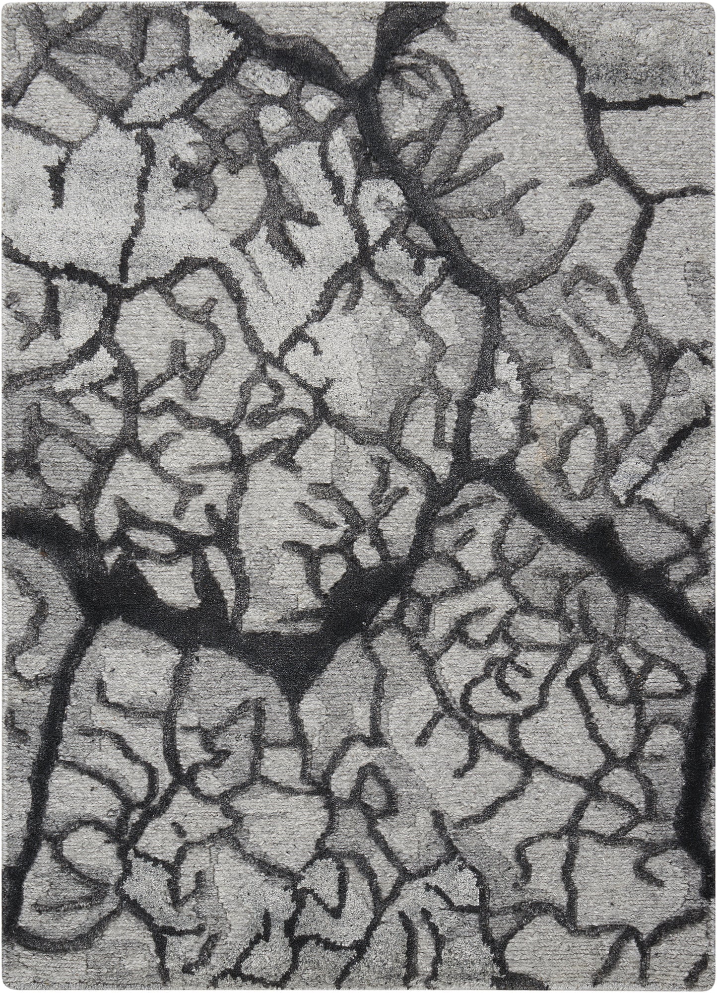 Close-up of gray dried mud with dark jagged fissures and rough surface.