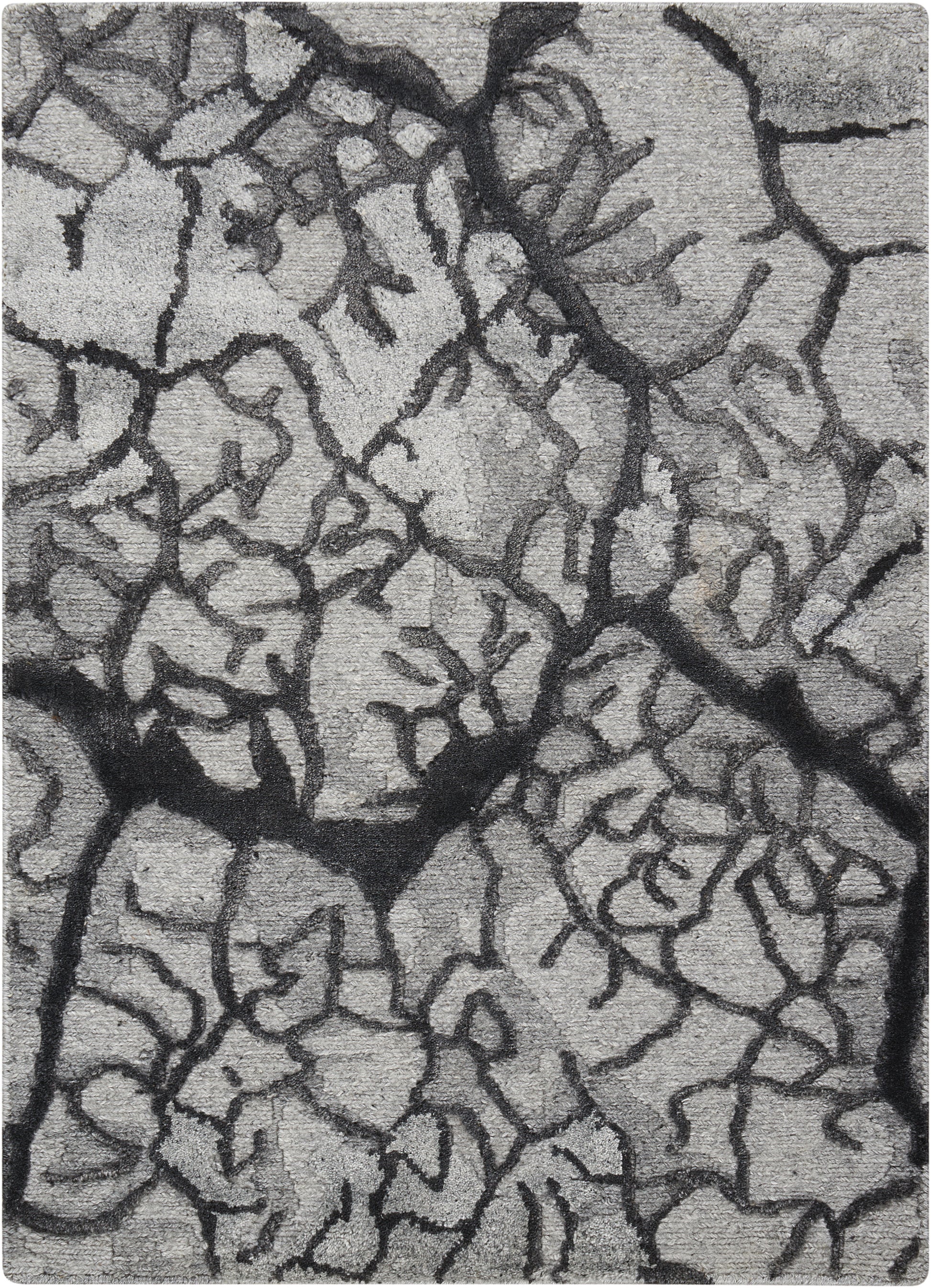 Close-up of gray dried mud with dark jagged fissures and rough surface.